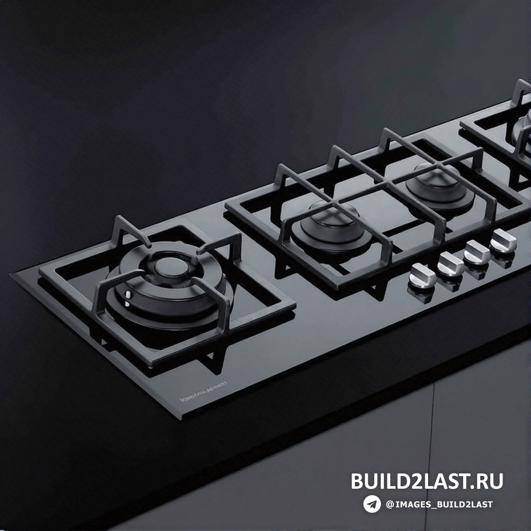 Черная варочная панель, кухонная мойка, смеситель и металлические элементы